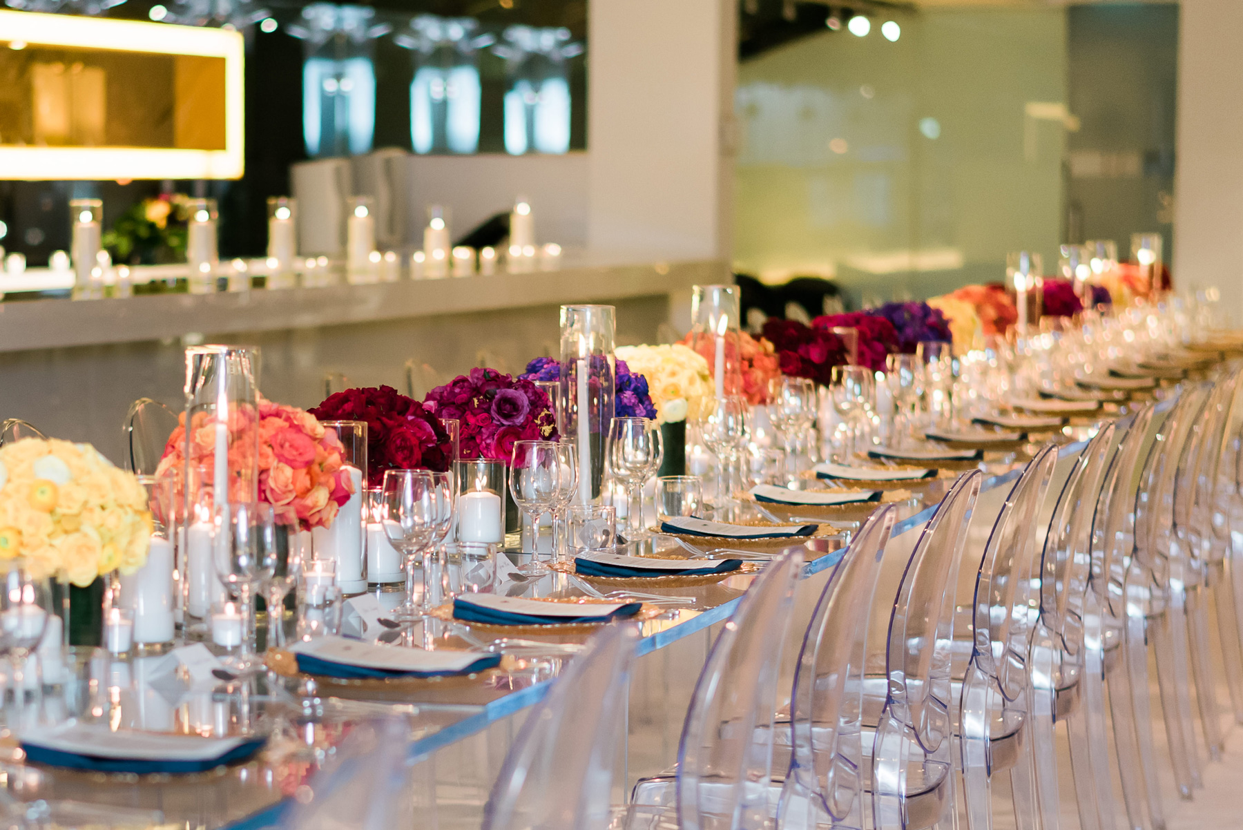 rows of candles and colorful monochromatic centerpieces 