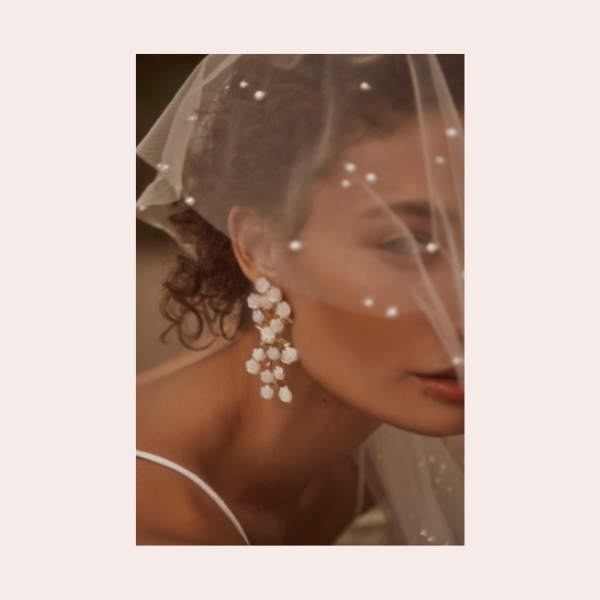 (4) Nicola Bathie Morwen Earrings $280.00 | Mother of pearl roses perched on golden stems make these chandeliers our favorite kind of bridal bouquet.